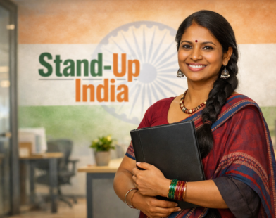 Confident Indian woman entrepreneur holding a folder in a modern office with Stand-Up India text and Indian flag backdrop.